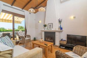 a living room with a couch and a fireplace at Can Clavell in Artá