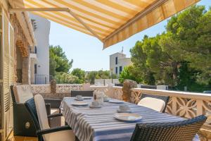 a table with a blue and white table cloth on a patio at Can Clavell in Artá