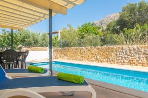 a villa with a pool and a table and chairs at Can Clavell in Artá