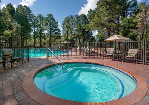 a hot tub in a patio with chairs and tables at Little America Hotel Flagstaff in Flagstaff