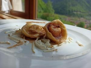 Un plato blanco con aros de cebolla. en Albergo Miravalle, en Forni Avoltri