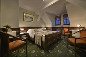 A bed or beds in a room at Hotel Podhrad
