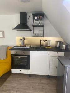 a small kitchen with a sink and a stove at city roof in Teterow