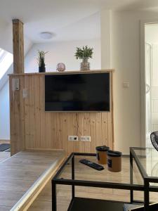 a living room with a tv and a coffee table at city roof in Teterow