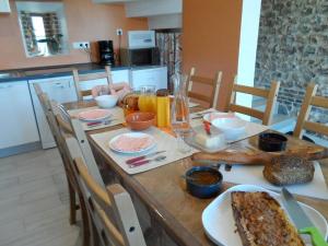 a wooden table with food on it in a kitchen at A L'Oree Du Lin in Mentheville