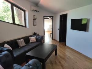 a living room with a couch and a table at Villa Arbanashki Han in Arbanasi