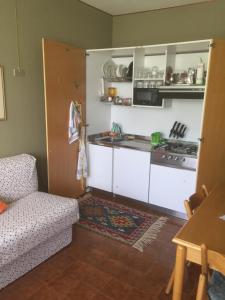 a kitchen with white cabinets and a stove top oven at 1° RESIDENCE GARESSIO 2000 in Borgo Ponte