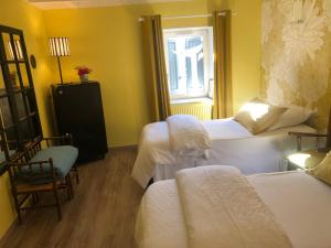 a hotel room with two beds and a window at La Gatille in Villié-Morgon +9 photos