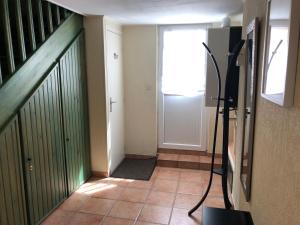 a hallway with a door and a television in a room at Casa Parcului in Villers-sur-Mer