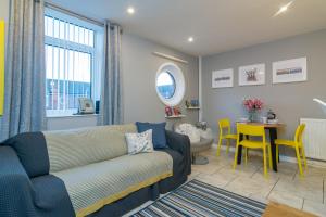 a living room with a couch and a table at Central Belfast Apartments, Salisbury in Belfast