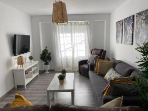 a living room with a couch and a tv at Apartamento Corazón de Cazorla by Clabao in Cazorla