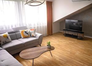 a living room with a couch and a table at Modern Apart w Centrum in Chełm