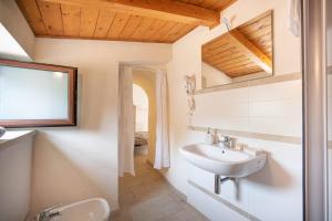 a bathroom with a sink and a mirror at WePuglia - Canto dei Grilli in Noci