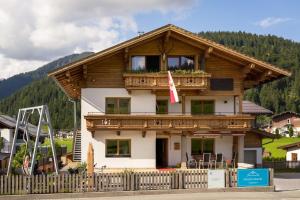 a house with a balcony on top of it at Grand Chalet Hochfilzen in Hochfilzen