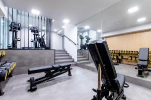 a gym with a bench and dumbbells at Resort Apartamenty Klifowa Rewal 21 in Rewal