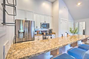 a kitchen with a granite counter top and a refrigerator at 5 Mi to Ski Resort: Breck Penthouse Studio in Breckenridge