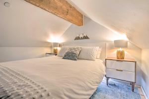 a bedroom with a white bed and two lamps at 5 Mi to Ski Resort: Breck Penthouse Studio in Breckenridge