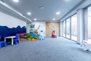 a childs room with a play area and a climbing wall at Resort Apartamenty Klifowa Rewal 27 in Rewal