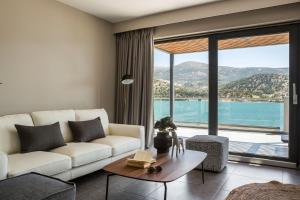 a living room with a white couch and a large window at The Twelve Suites Collection in Argostoli