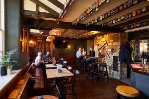 a group of people sitting at tables in a restaurant at The Quarrymans Arms in Corsham