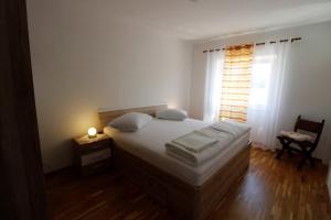 a bedroom with a large bed and a window at Apartment Karlo Vis in Vis +18 photos