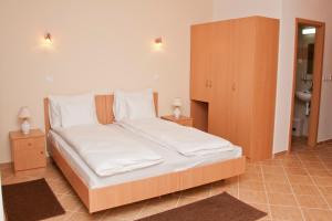 a bedroom with a large white bed with two night stands at Esprit Hotel in Budapest