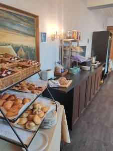 a bakery with several racks of bread and pastries at De Basiliek in Edegem