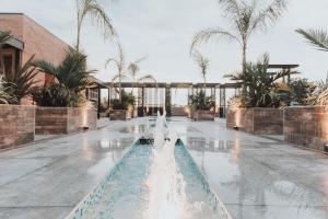 a swimming pool with a fountain in a resort at Hotel Soho Suites in San Francisco