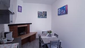 a dining room with a table and a fireplace at Casa vacanza Viola in Trapani