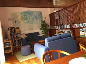 a living room with a blue couch and a table at Tavira Small cozy flat by the pool and by the sea in Tavira