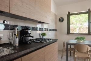 a kitchen with a black counter top and a table at IL GIARDINO in Procida +21 photos