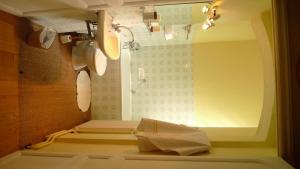 a bathroom with a shower with a window and a toilet at Château du Prada in Labastide-dʼArmagnac
