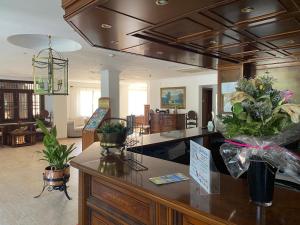 a living room with a counter with flowers on it at Hs Villa Rosa Paguera in Paguera