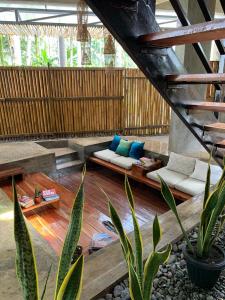 a living room with a couch and some plants at Kaha Island Stay in Santa Monica