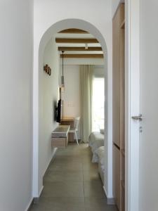 a hallway with an archway leading to a bedroom at Sea-duction Studios in Nea Iraklia