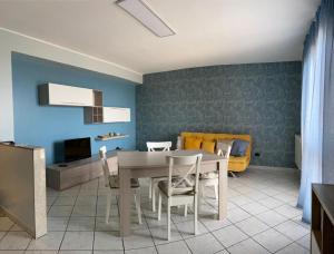 a kitchen and dining room with a table and chairs at Augustali Momenti Apartment in Centuripe