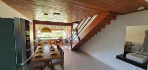 a dining room with a table and a staircase at WinterVille Gravatá 418 in Gravatá
