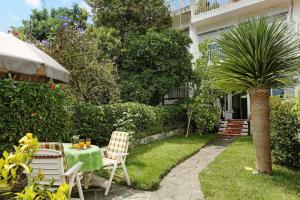 un jardin avec une table, des chaises et un palmier dans l'établissement Casa Marion, à Teror