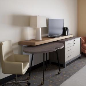 a desk with a computer and a chair and a lamp at Holiday Inn Lansdale-Hatfield, an IHG Hotel in Kulpsville