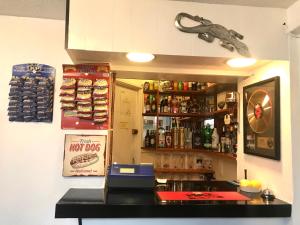 a bar with a counter and a shelf with alcohol at The Southwold Guest House in Skegness