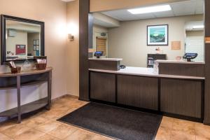 a waiting room with a hair salon with a mirror at Candlewood Suites Paducah, an IHG Hotel in Paducah