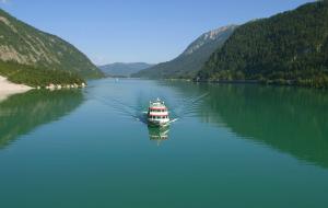 a boat in the middle of a large body of water at Haus Alpenblick in Pertisau