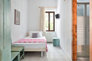 a bedroom with a bed and a table and a window at S'Enis Monte Maccione in Oliena
