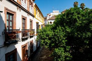 an alley between two buildings in a city at Doña Elvira Suites Cathedral in Seville
