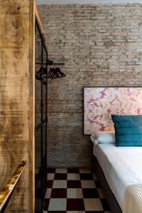 A bed or beds in a room at Doña Elvira Suites Cathedral