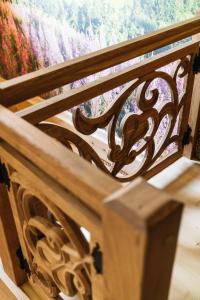 a wooden bench sitting in front of a window at NA BALI po góralsku in Poręba Wielka