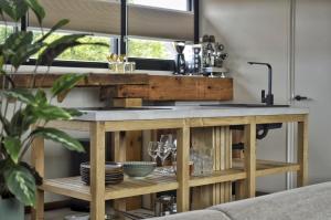 a kitchen with a counter with glasses on it at Van Heeckeren Apartments & Suites Buren in Buren