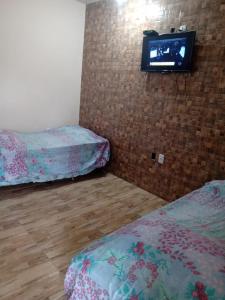 Giường trong phòng chung tại Aconchego Baiano - Coroa Vermelha - Cabrália - BA.