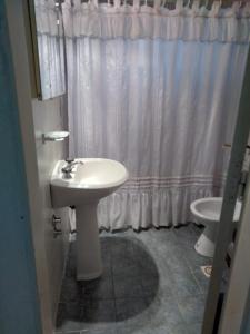 a bathroom with a white sink and a toilet at Hermoso departamento en Mendoza in Mendoza
