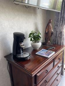 a wooden dresser with a coffee maker on top of it at Parel van Bever - Perle de Biévène in Bever